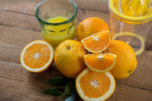 Stock photo: Close-up of oranges with glasses of juice and juicer