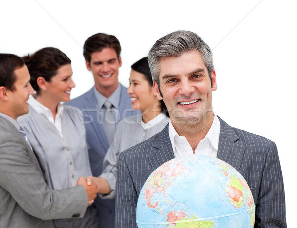 Mature manager holding a terrestrial globe in front of his team Stock photo © wavebreak_media