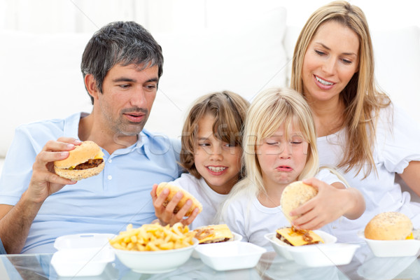 Merry family eating hamburgers Stock photo © wavebreak_media