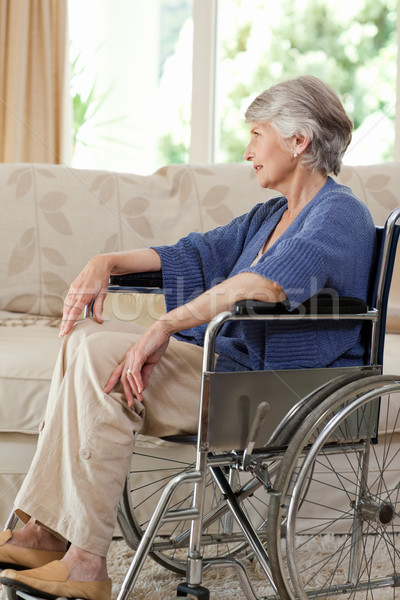 Stock photo: Retired woman in her wheelchair at home