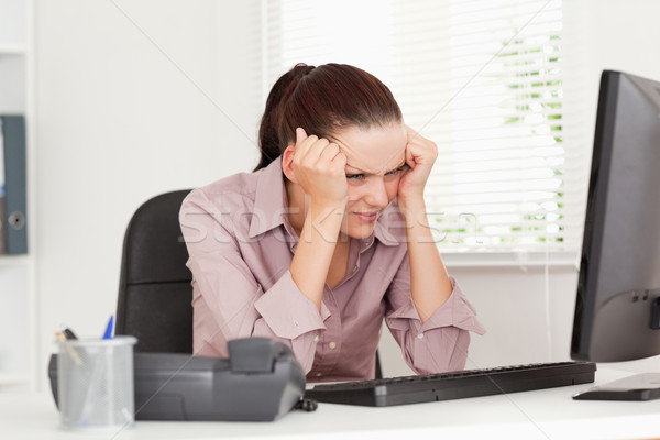 A frustrated businesswoman sitting in her office Stock photo © wavebreak_media