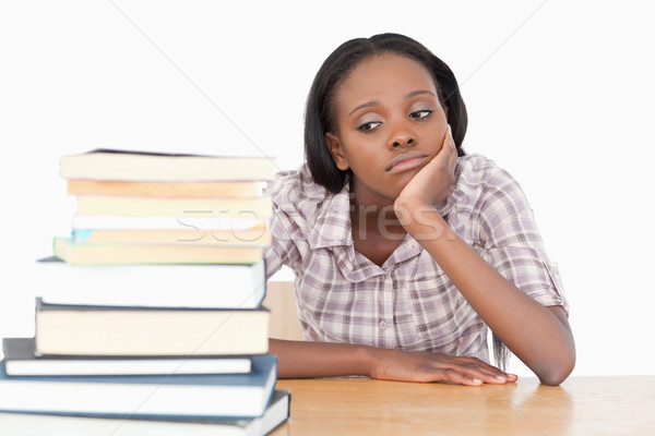 Bored student looking at a stack of books against a white background Stock photo © wavebreak_media
