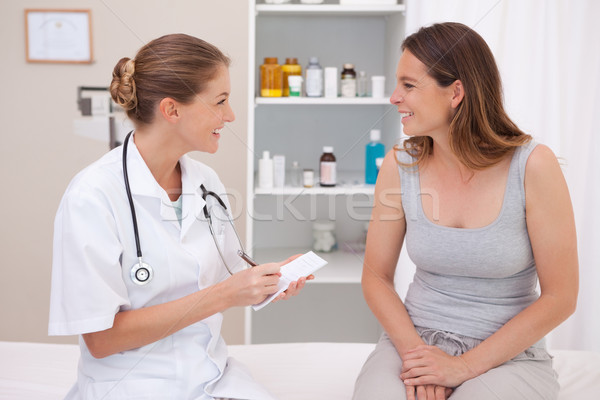 Stock photo: Smiling doctor with patient in examination room