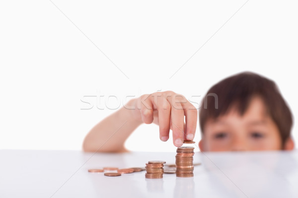 Young boy counting his change against a white background Stock photo © wavebreak_media
