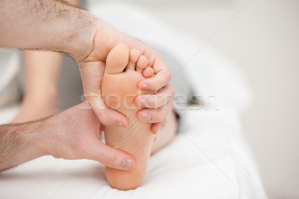 Two hands holding a foot in a room Stock photo © wavebreak_media
