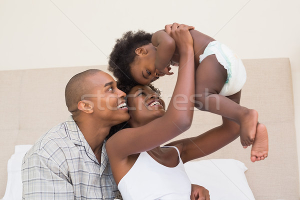 Happy couple on bed with baby daughter Stock photo © wavebreak_media