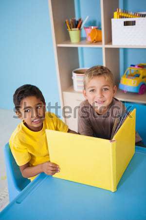 Cute little boys reading at desk in classroom Stock photo © wavebreak_media