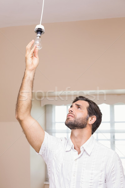 Man replacing the light bulb Stock photo © wavebreak_media