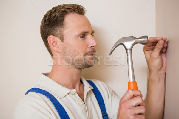 Man hammering nail in the wall Stock photo © wavebreak_media