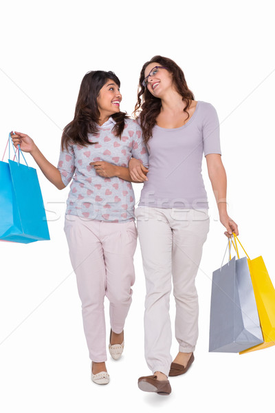 Smiling friends walking with shopping bags Stock photo © wavebreak_media