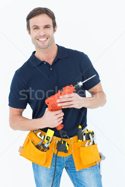 Confident carpenter holding portable drill machine Stock photo © wavebreak_media