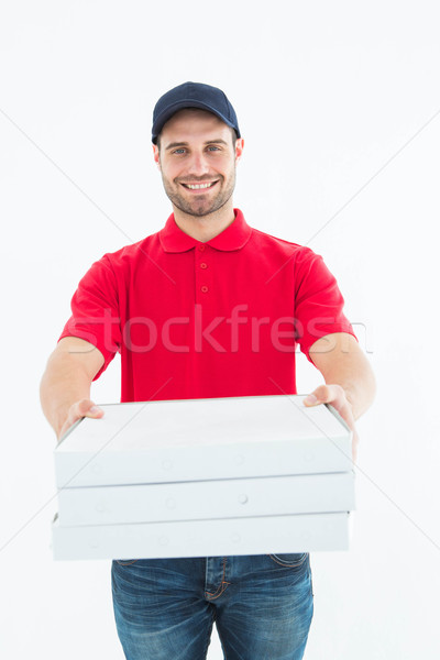 Happy delivery man giving pizza boxes Stock photo © wavebreak_media