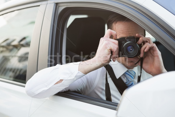 Businessman taking picture while sitting in the drivers seat Stock photo © wavebreak_media