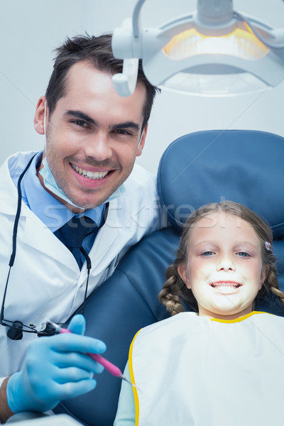 Male dentist examining girls teeth Stock photo © wavebreak_media