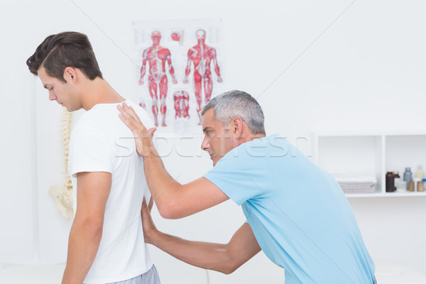 Stock photo: Doctor examining his patient back 