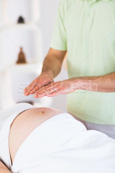 Close up view of pregnant woman getting reiki treatment Stock photo © wavebreak_media