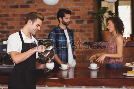 Pretty customer making a mobile payment Stock photo © wavebreak_media