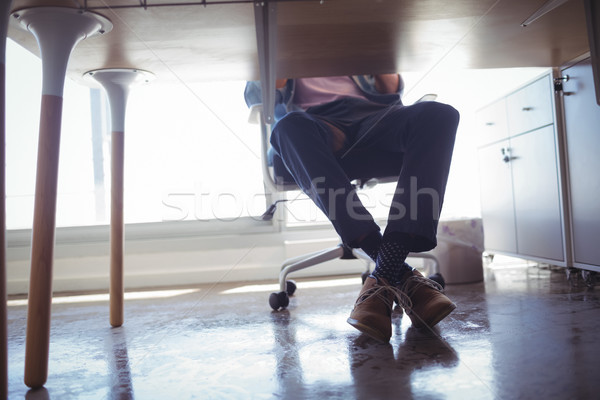 Low section of businessman sitting at desk in office Stock photo © wavebreak_media