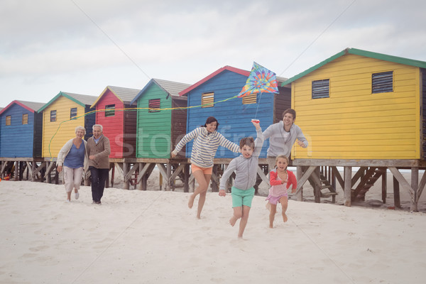 Heureux famille courir plage sable ciel [[stock_photo]] © wavebreak_media