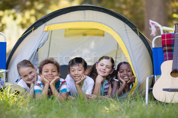 Smiling friends resting in tent at campsite Stock photo © wavebreak_media