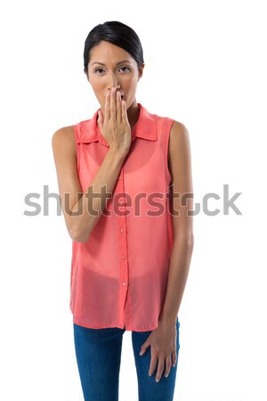 Woman covering her mouth with hand against white background Stock photo © wavebreak_media