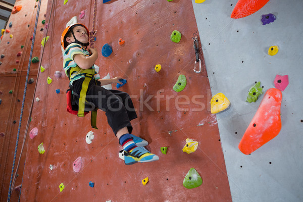 Boy practicing rock climbing in fitness studio Stock photo © wavebreak_media