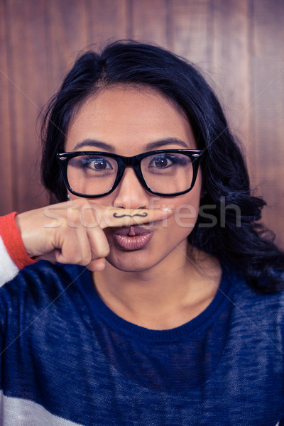 Asian femme moustache doigt bois mur [[stock_photo]] © wavebreak_media