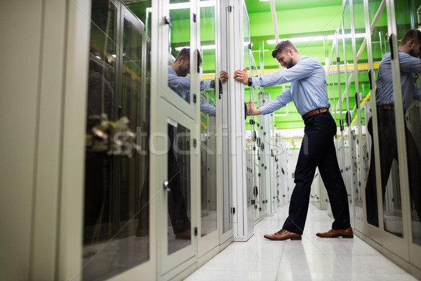 Technician adjusting server cabinet Stock photo © wavebreak_media