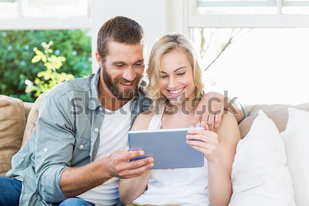Happy couple using digital tablet on beach Stock photo © wavebreak_media