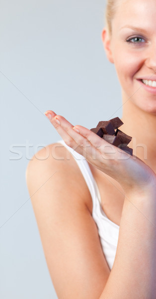 Stock photo: Beautiful woman holding chocolate focus on chocolate 