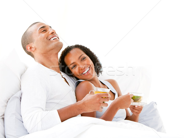 Alegre casal potável copo chá cama Foto stock © wavebreak_media