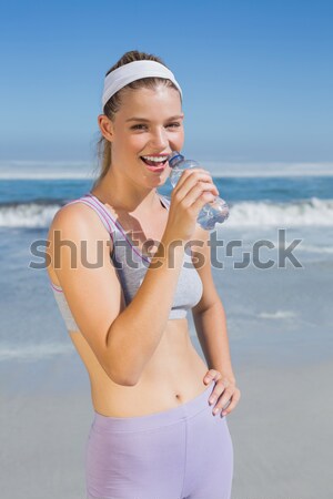 Stock photo: Caucasan young woman eating ice-cream on the beach