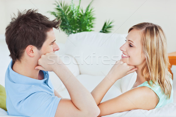 Young couple playing to look at each other sitting on the sofa at home Stock photo © wavebreak_media