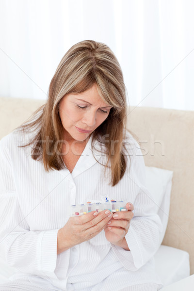 Sick woman taking her pills at home Stock photo © wavebreak_media