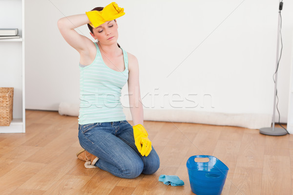 Stock photo: Pretty red-haired woman having a break while cleaning the floor at home