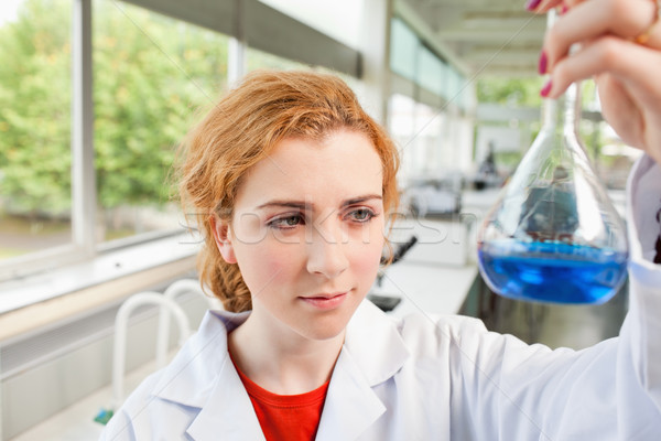 Cute science student holding a blue liquid in a laboratory Stock photo © wavebreak_media