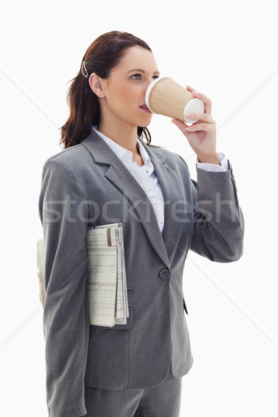 Close-up of a profile businesswoman with a newspaper and drinking a coffee against white background Stock photo © wavebreak_media