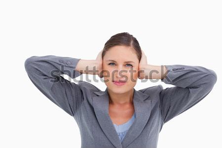Close up of tradeswoman covering ears against a white background Stock photo © wavebreak_media