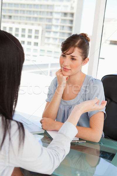 Brunette and black haired co workers chat to one another in an office Stock photo © wavebreak_media