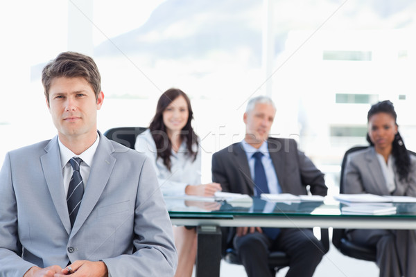 Earnest businessman sitting in front of his team in a well-lit room Stock photo © wavebreak_media