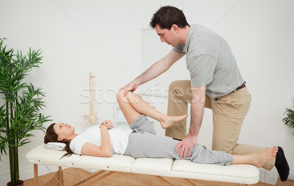 Woman being examining her leg by a chiropractor in a medical room Stock photo © wavebreak_media