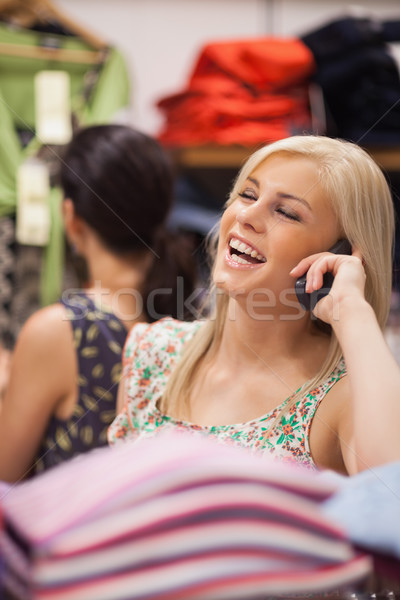 Woman is phoning in the shop while laughing  Stock photo © wavebreak_media