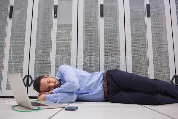 Man sleeping while doing maintenance on servers with laptop Stock photo © wavebreak_media