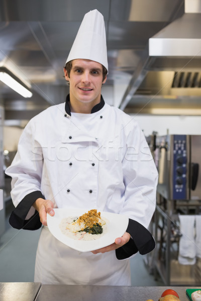 Smiling chef presenting his plate in the kitchen Stock photo © wavebreak_media