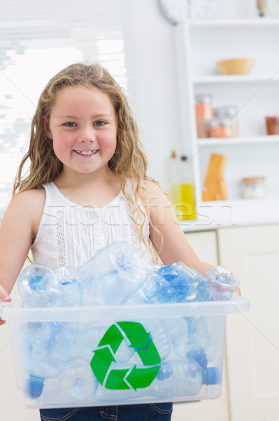 Smiling girl carrying recycling box of the plastics bottles Stock photo © wavebreak_media