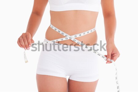 Midsection of woman measuring waist Stock photo © wavebreak_media