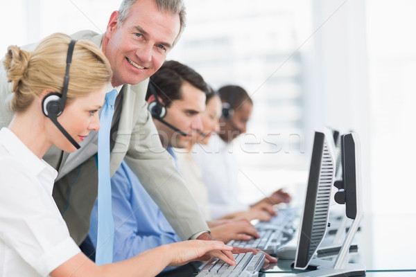 Stock photo: Manager and executives with headsets using computers