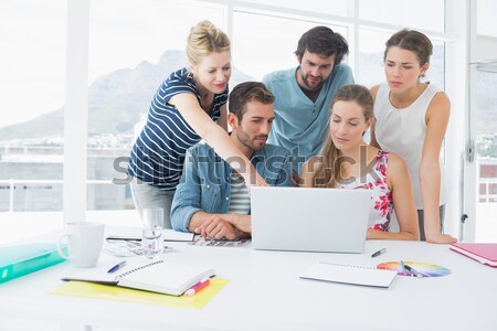 Casual business people using laptop together Stock photo © wavebreak_media