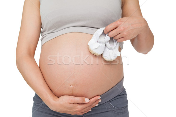 Terhes nő tart babacipők dudorodás fehér nő Stock fotó © wavebreak_media
