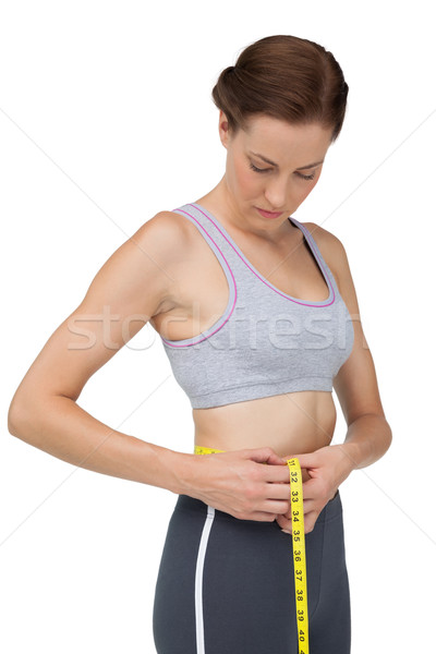 Portrait of a fit woman measuring waist Stock photo © wavebreak_media